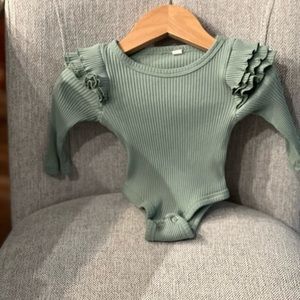 Green onesie with ruffles